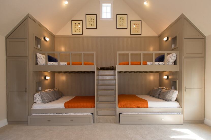 Built-in steps with drawer storage divide full-over-queen bunk beds designed by John Boyd....