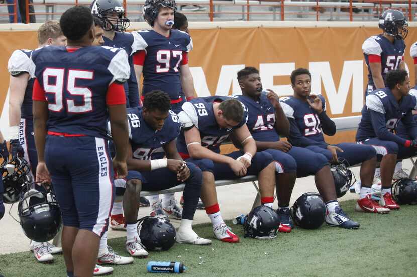 Allen players sit dejectedly late in the fourth quarter during the UIL Class 6A Division I...
