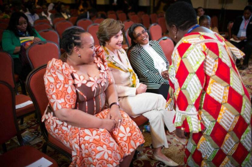 Former first lady Laura Bush talks to South African first lady Nompumelelo Ntuli Zuma...