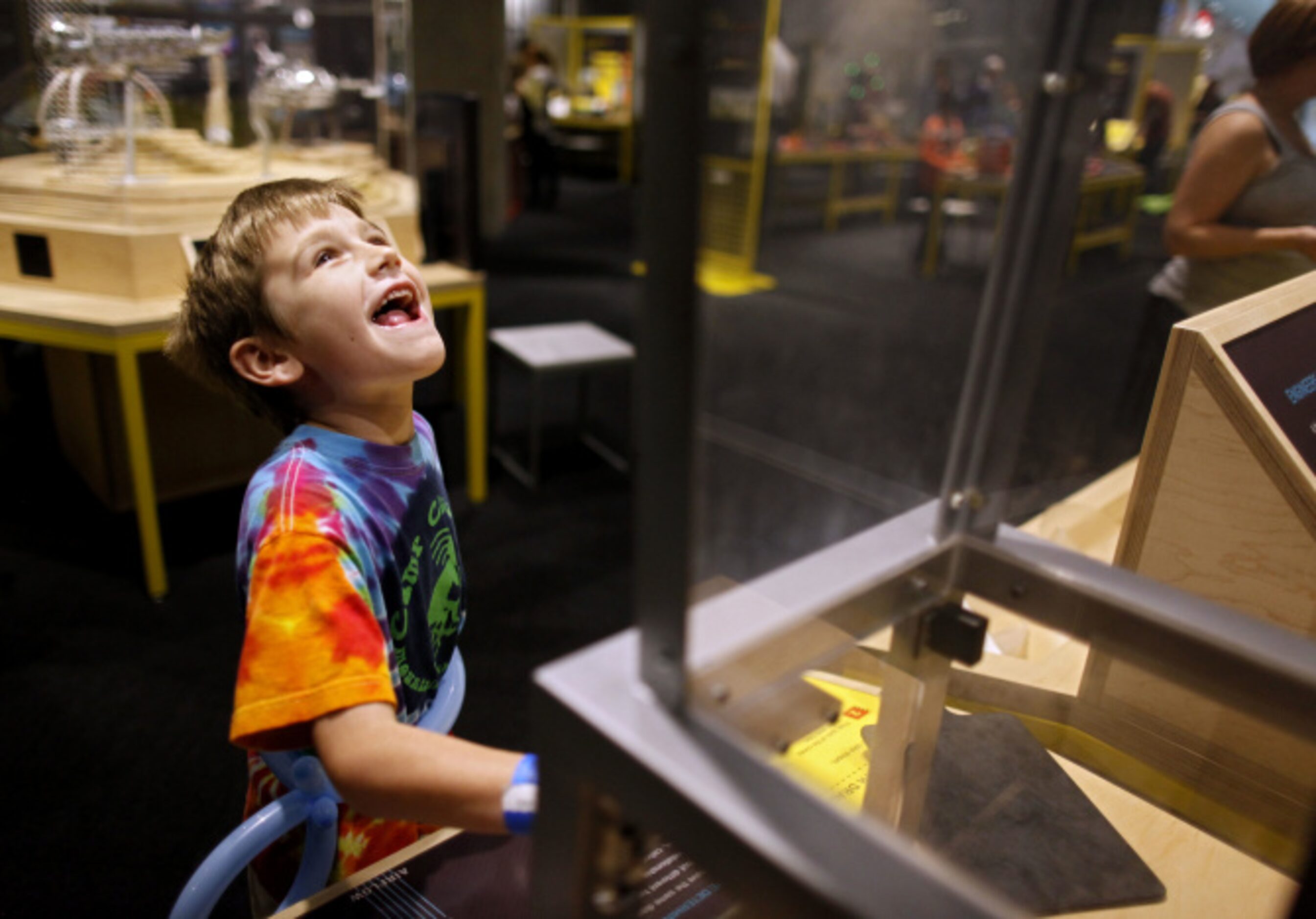 Grey Sargent, 6 of Dallas watches a shape go up a tunnel forced by air as he plays in the...