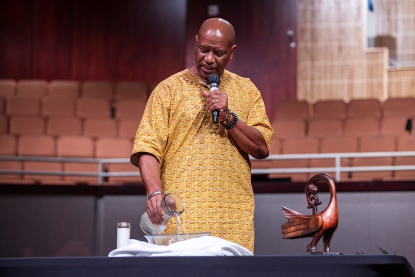 William E. White, Pastor of Discipleship, pours a vase of water in remembrance of the people...