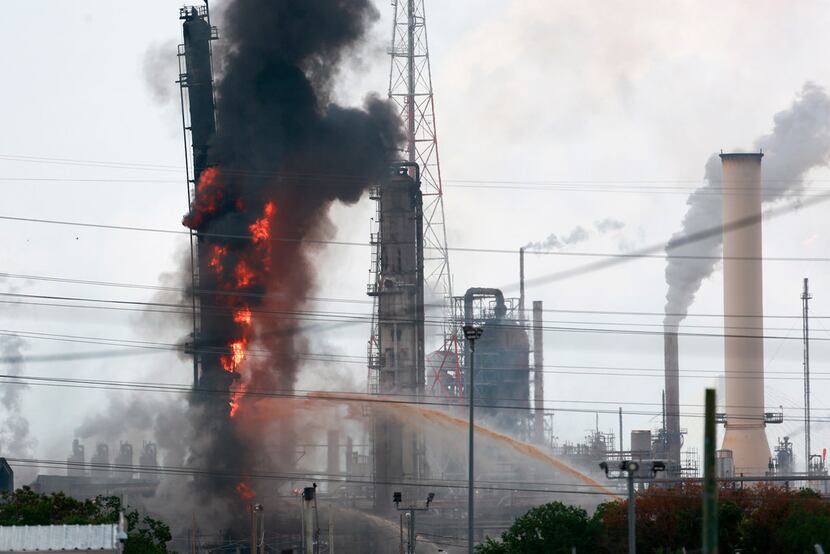 Flames and smoke rise after a fire started at an Exxon Mobil facility, Wednesday, July 31,...