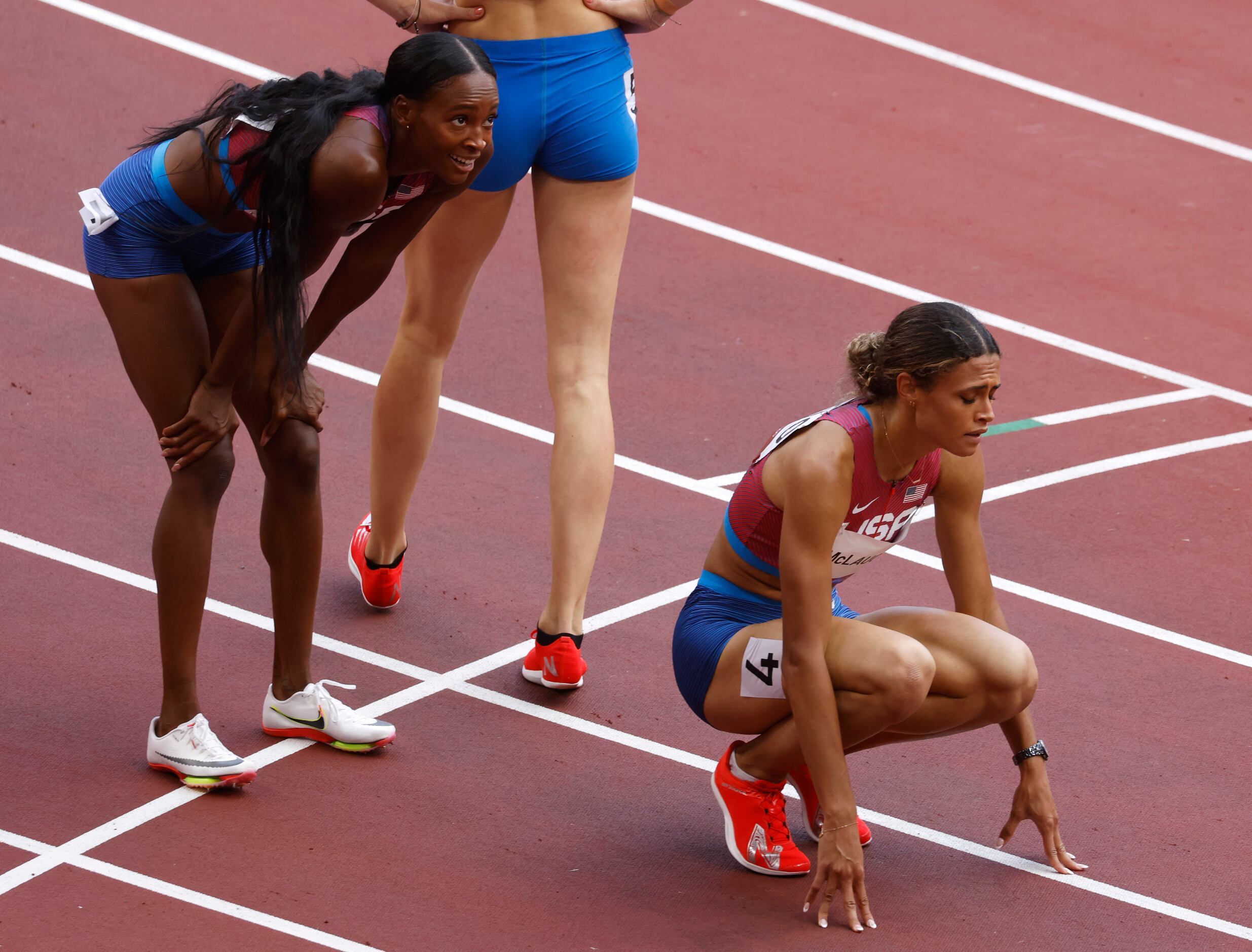 USA’s Sydney McLaughlin (right) and USA’s Dalilah Muhammad watch the replay after they...