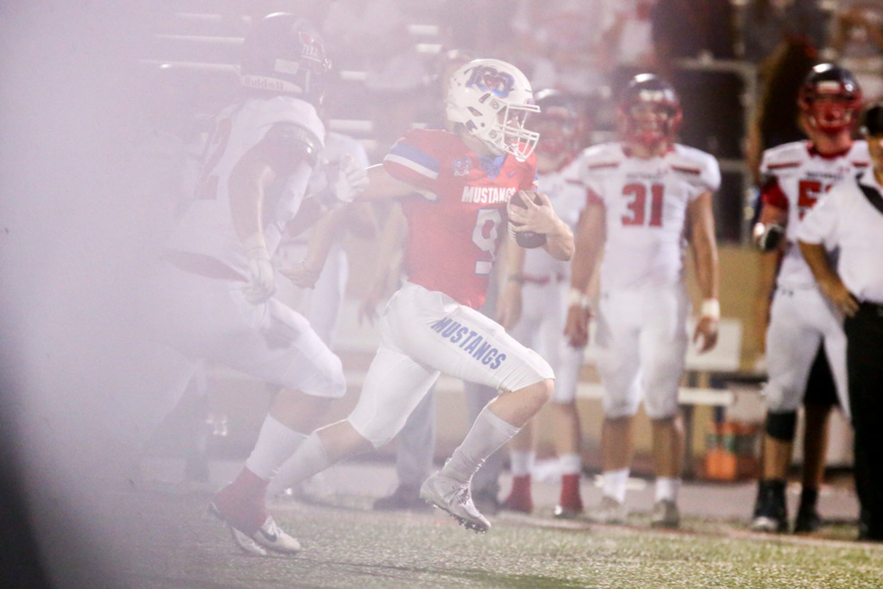 Grapevine quarterback Austin Alexander (9) carries the ball past Northwest wide receiver...