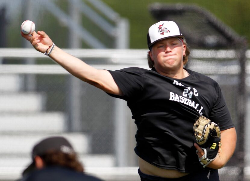 Argyle catcher Logan Gregory fired the ball after fielding a grounder during practice at...