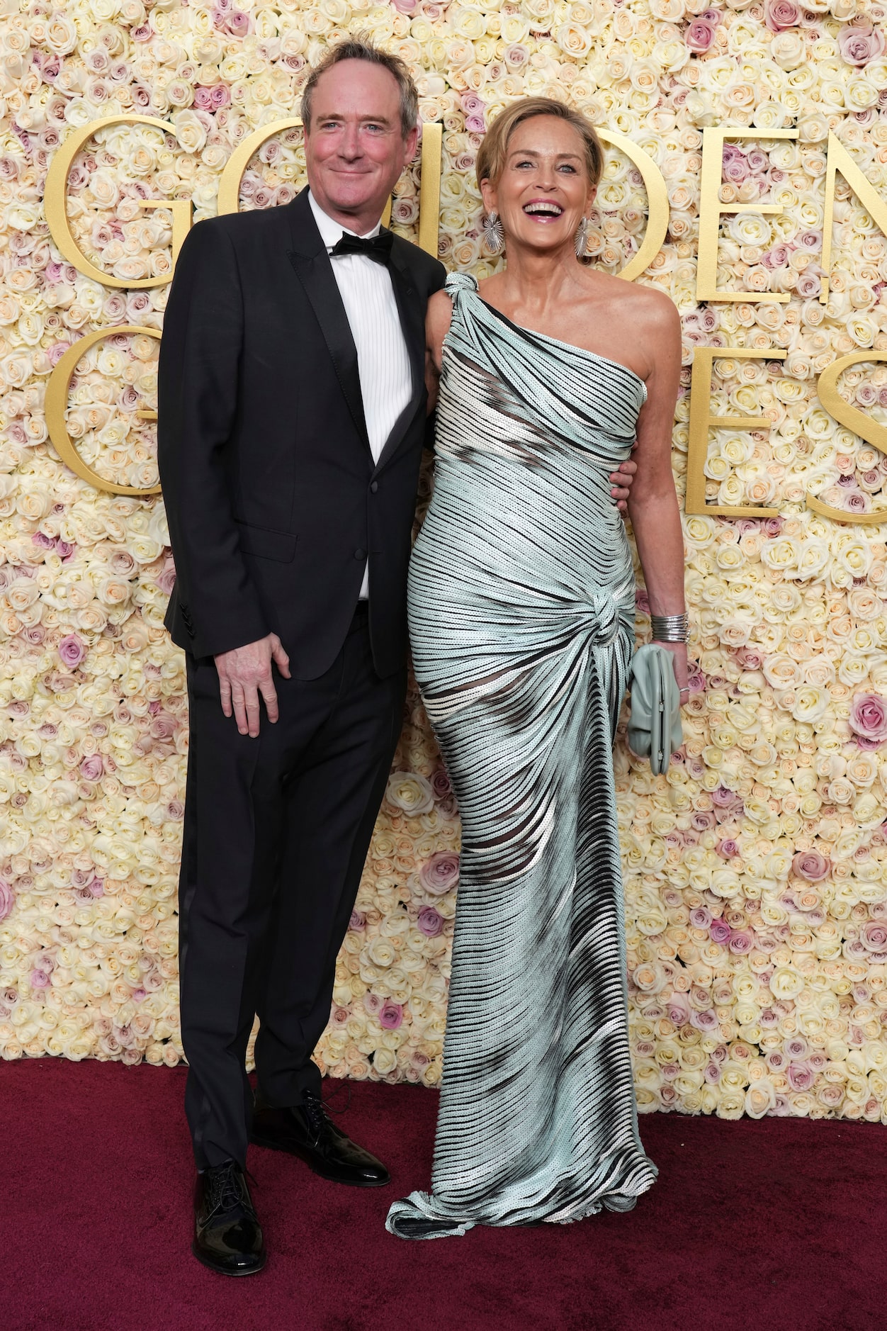 Jim Osborne, left, and Sharon Stone arrive at the 82nd Golden Globes on Sunday, Jan. 5,...