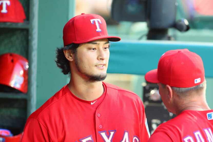 ARLINGTON, TX - JUNE 08: Yu Darvish #11 of the Texas Rangers talks with manager Jeff...