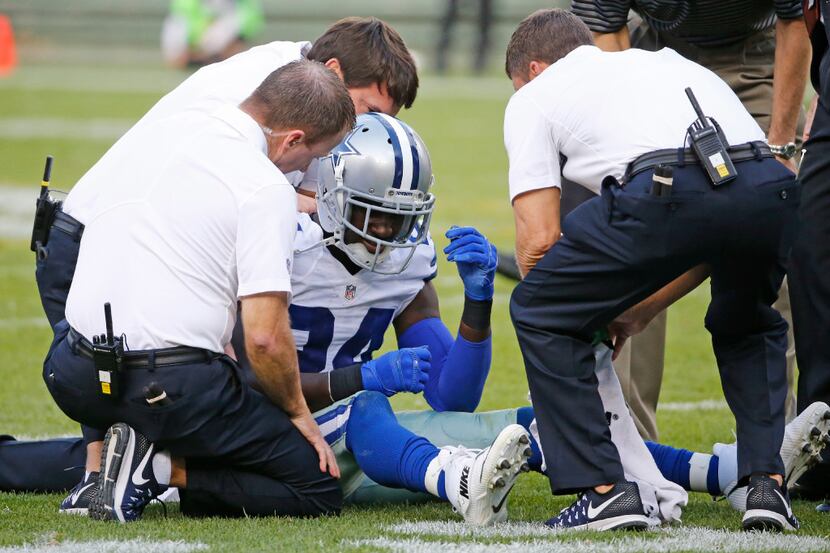 Medical personnel help Dallas Cowboys cornerback Morris Claiborne (24) after he collide with...