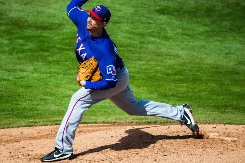 Texas Rangers starting pitcher Chi Chi Gonzalez (21) pitches during the third inning of a...
