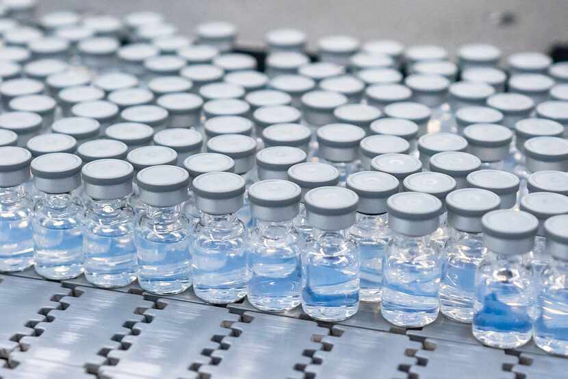 This August 2022 photo provided by Pfizer shows vials of the company's updated COVID-19...