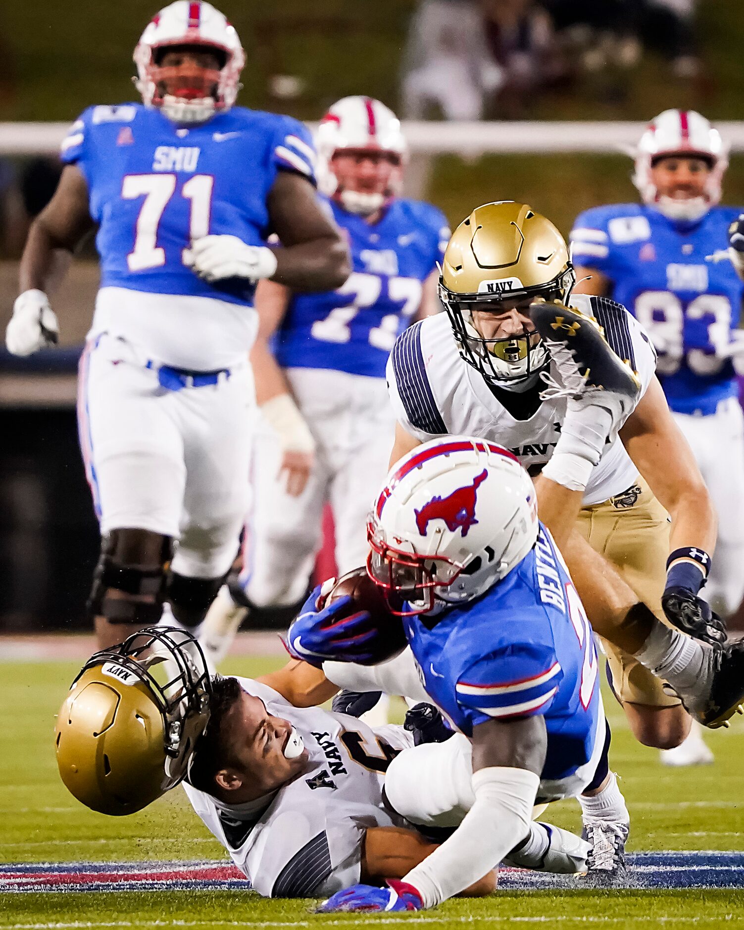 SMU running back Ulysses Bentley IV (26) is brought down by Navy defensive back Mitchell...