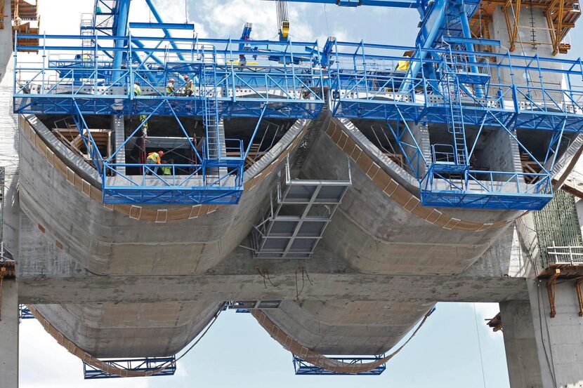 Tour boats give  visitors a glimpse of workers creating one of the biggest bridge projects...