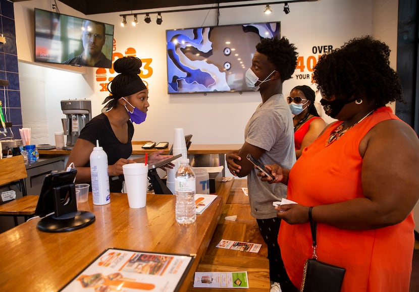 Mary Jones (left) takes orders at BurgerIM on Sunday, May 31, 2020 in Dallas. Many in the...