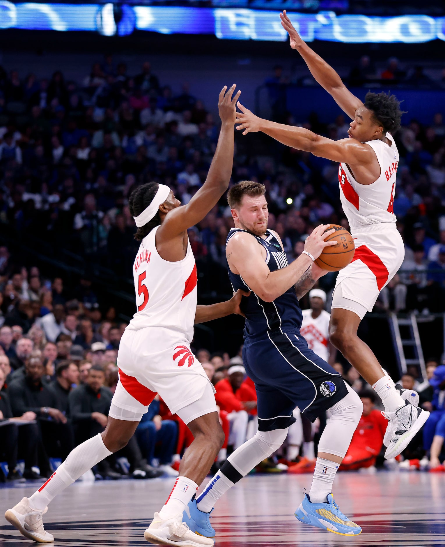 Dallas Mavericks guard Luka Doncic (77) is double teamed by Toronto Raptors forward Precious...