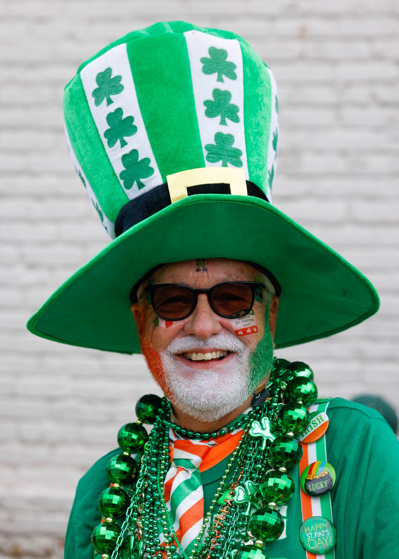 Larry Williams poses as he waits in line to get in a block party during a Saint Patrick's...