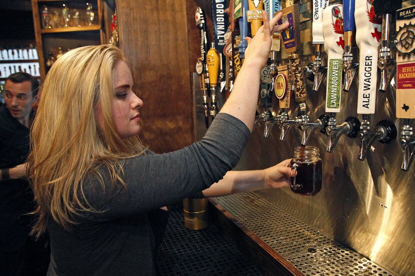 Stephanie Kennedy of McKinney, general manager at Ron's Place in Addison, draws a new craft...