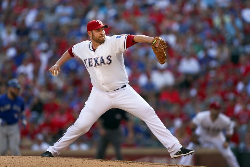 Texas Rangers relief pitcher Colby Lewis (48) throws against the Toronto Blue Jays in Game 4...