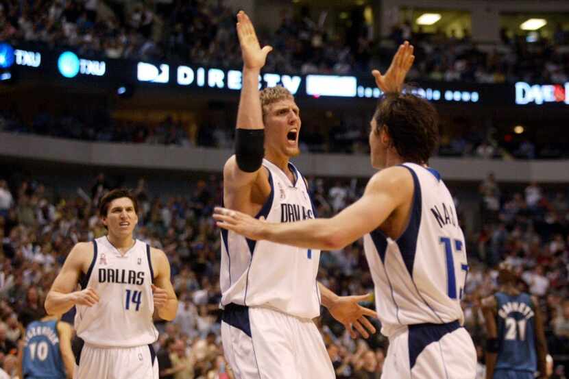 Dallas Mavericks Dirk Nowitzki (41) celebrates with Steve Nash (13) after Nowitzki rejected...