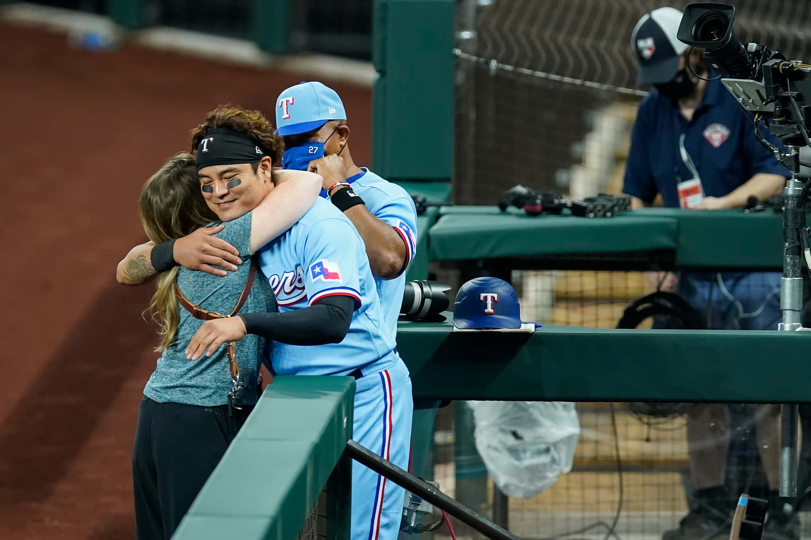 Texas Rangers outfielder Shin-Soo Choo hugs team photographer Kelly Gavin as third base...
