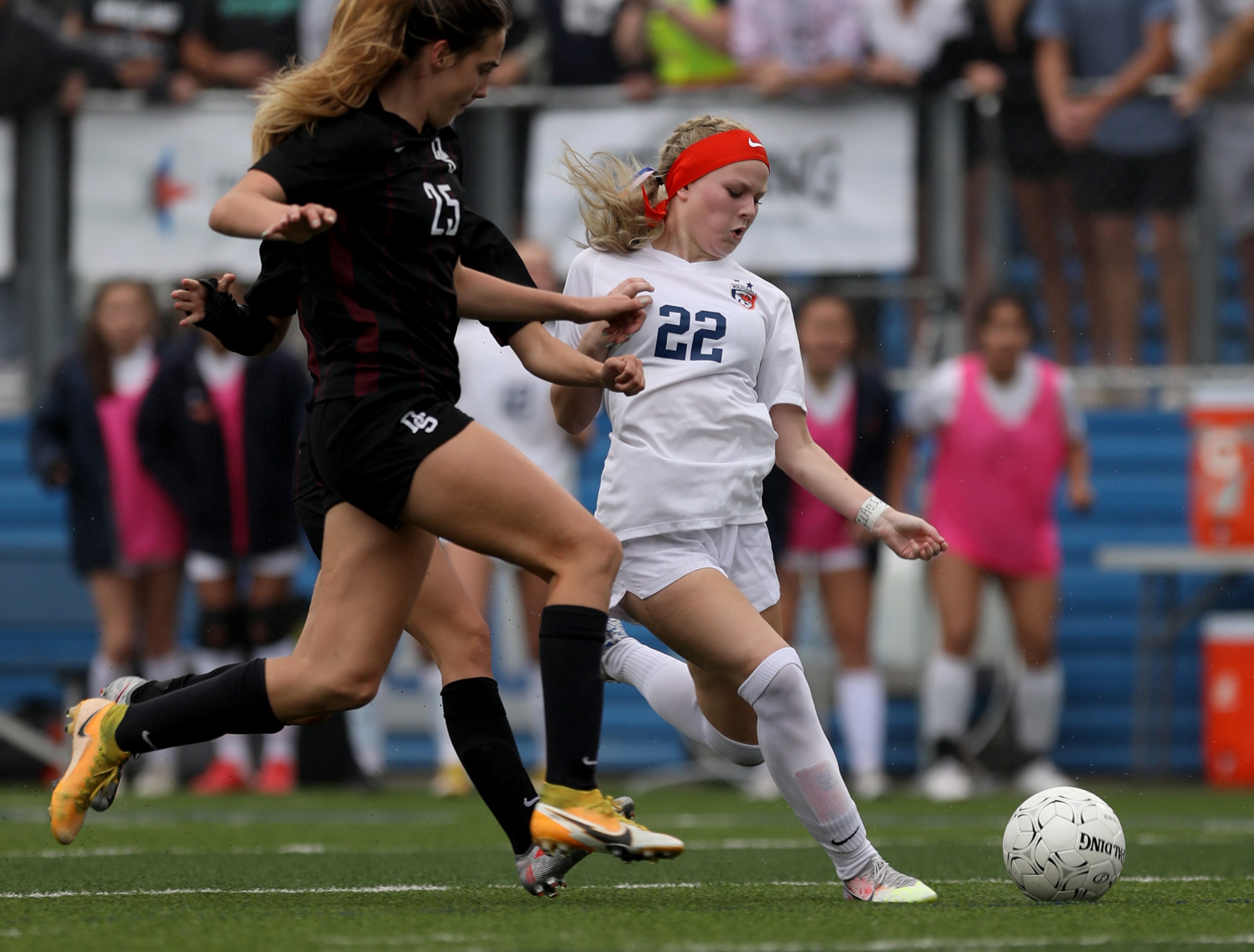 Wakeland's McKenna Jenkins (22) goes for the ball ahead of Dripping Springs' Laney Kalsu...