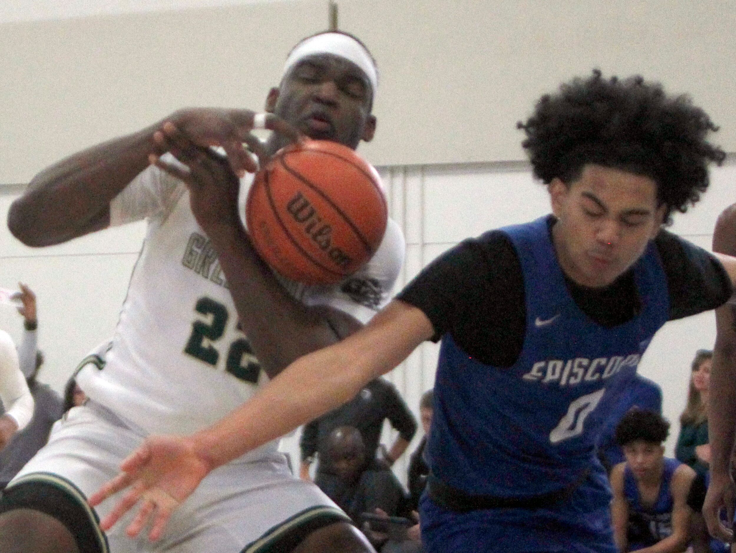 Greenhill's Lee Dort (22), left, has the ball knocked away by Houston Episcopal's Desean...