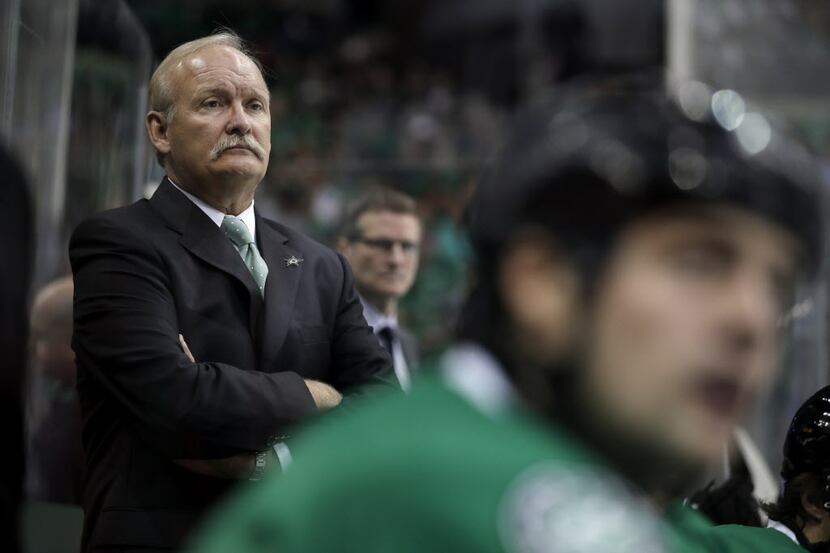 Dallas Stars coach Lindy Ruff watches from the bench in the first period of an NHL hockey...