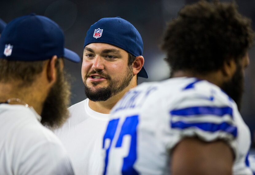 Dallas Cowboys offensive guard Zack Martin (70) talks to center Travis Frederick (72) near...