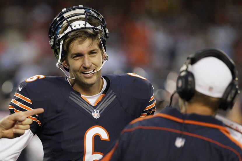 Chicago Bears quarterback Jay Cutler smiles as he talks with quarterbacks coach Jeremy Bates...
