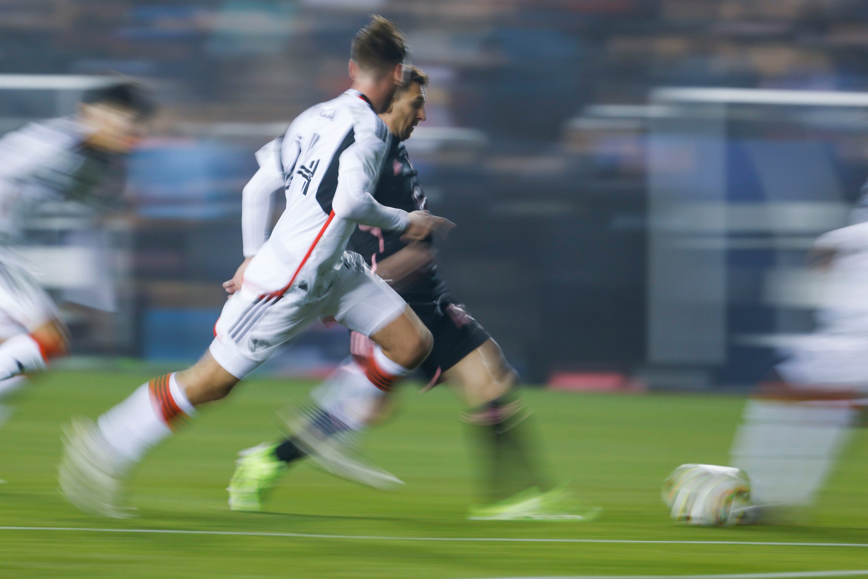 Inter Miami forward Lionel Messi (back) dribbles against FC Dallas defender Amet Korca...