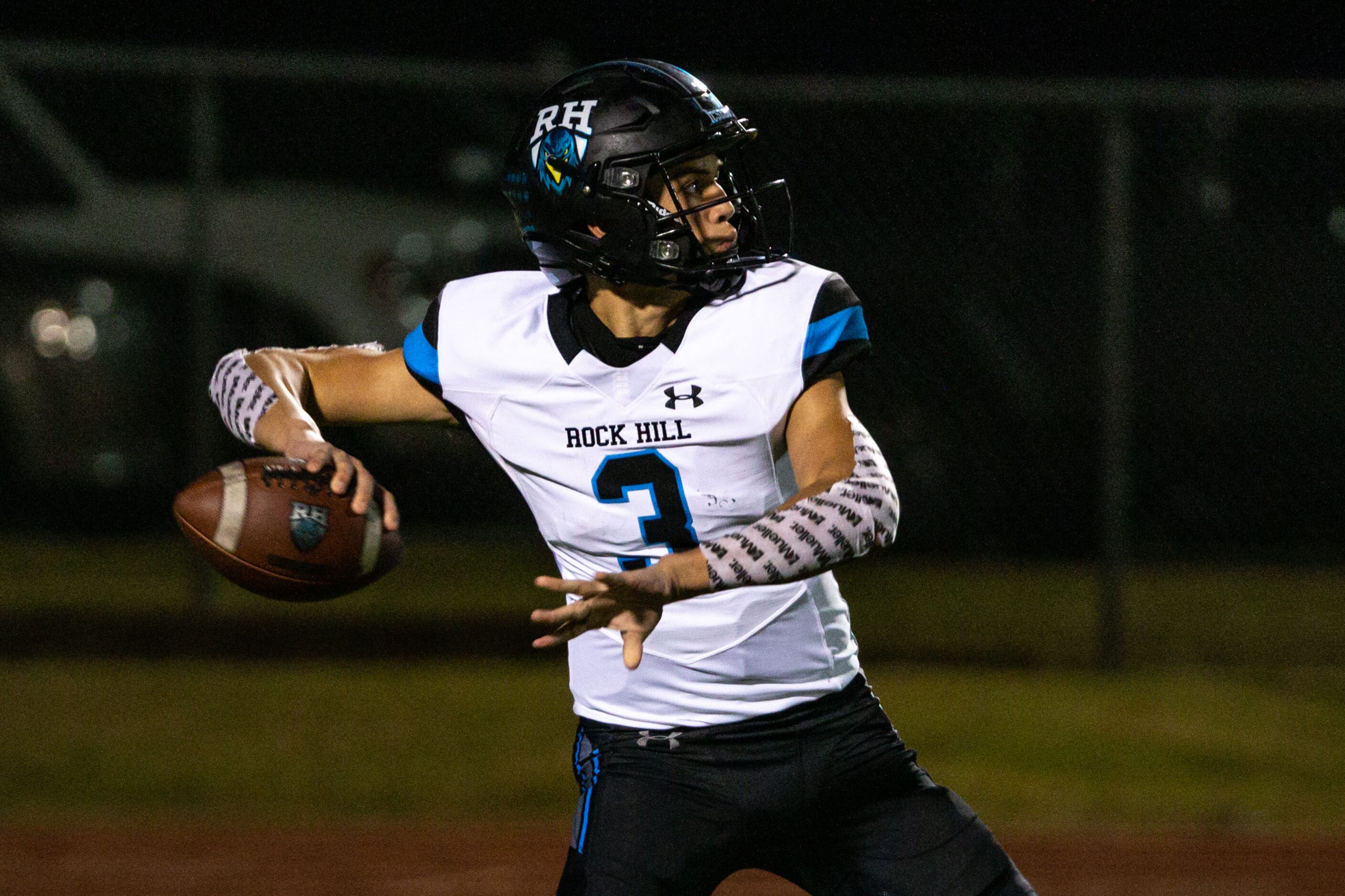 Rock Hill quarterback Brenner Cox (4) looks for room to pass during the first half of the...