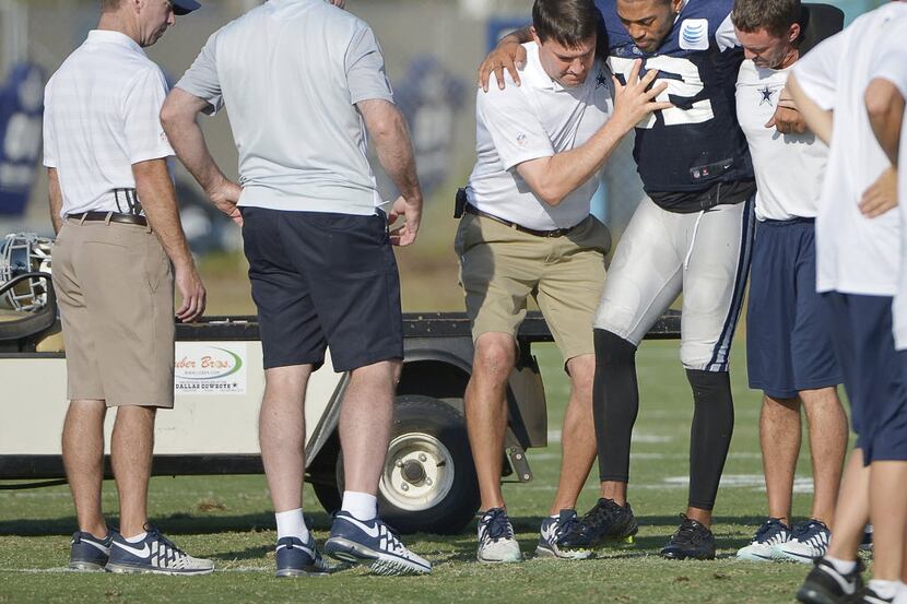 Dallas Cowboys cornerback Orlando Scandrick (32) is placed on a cart after injuring his knee...