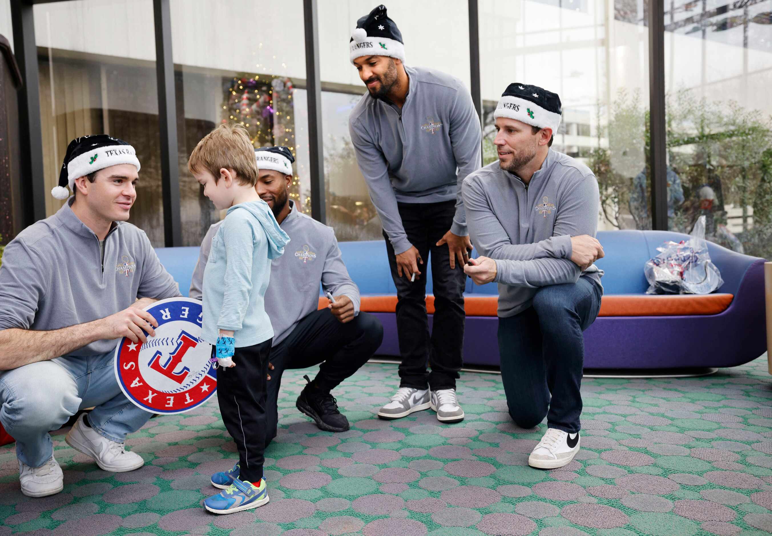 Texas Rangers pitcher Cody Bradford, from left, talks with Medical City Children’s Hospital...