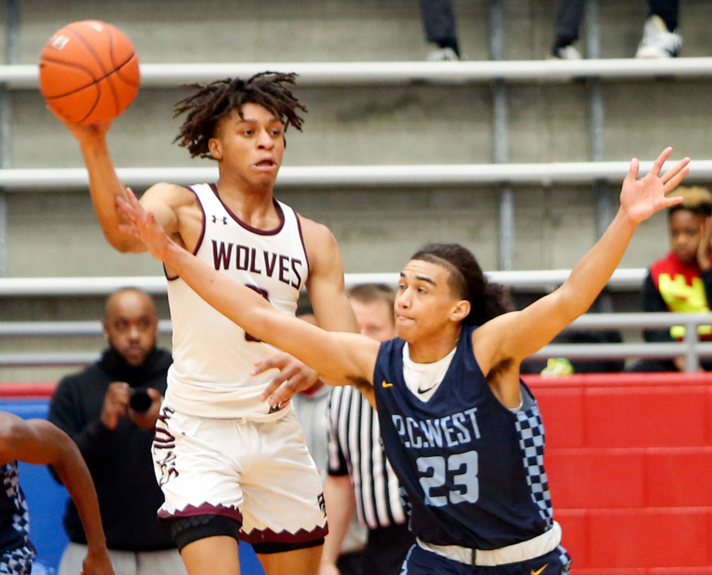 Mansfield Timberview senior Joey Madimba (0) leaps to pass over the defense of Putnam City...