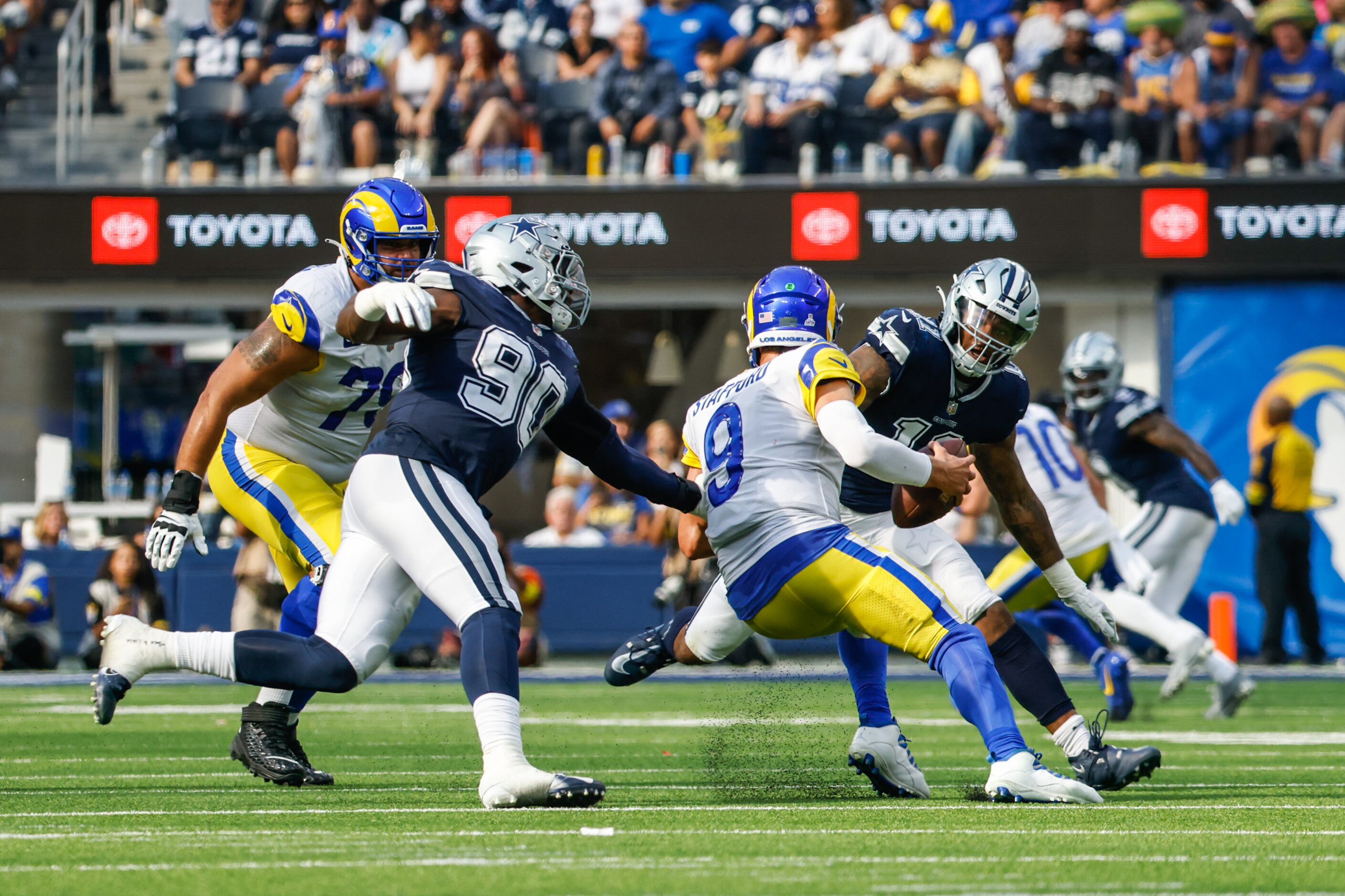 Los Angeles Rams quarterback Matthew Stafford (9) tries to not get gets sacked by Dallas...