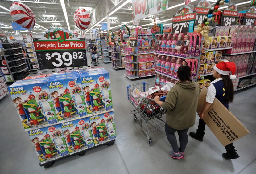 In this Wednesday, Oct. 26, 2016, photo, a shopper, left, walks with a store associate in...