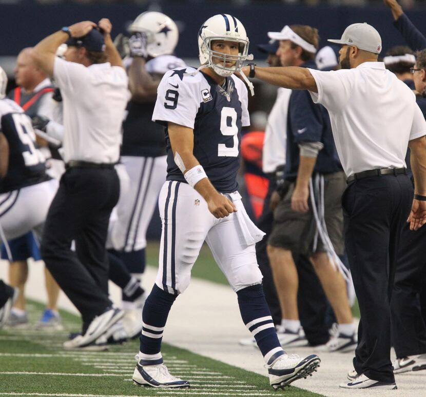 Dallas quarterback Tony Romo (9) walks off the field after throwing an interception in the...