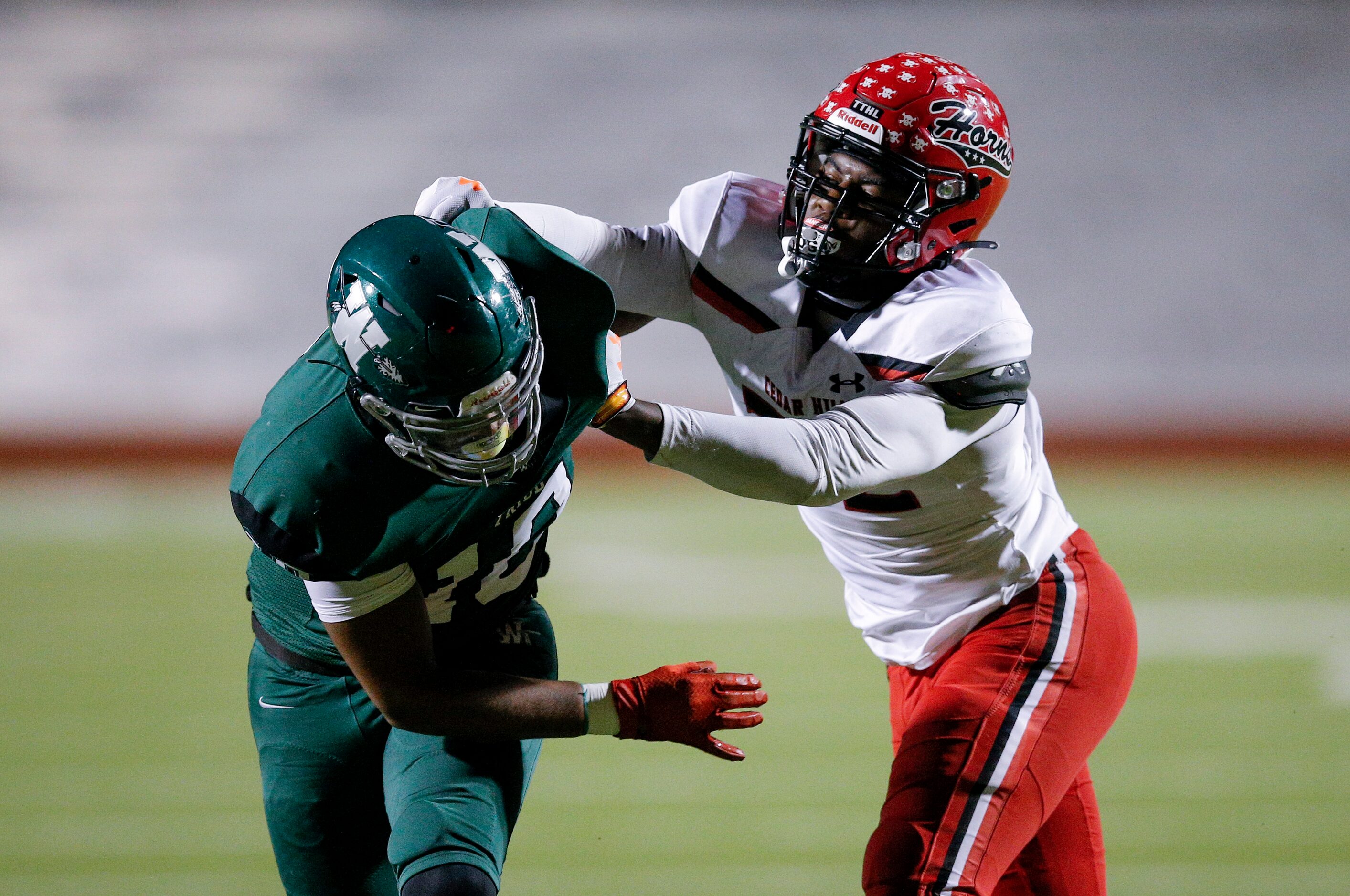 Cedar Hill senior defensive end Charles Esters III (32) battles Waxahachie junior tight end...