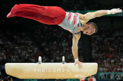 Paul Juda  of the United States competes on the pommel horse during the men’s gymnastics...
