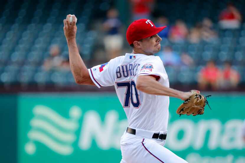 Texas Rangers starting pitcher Brock Burke throws to the Los Angeles Angels in the first...