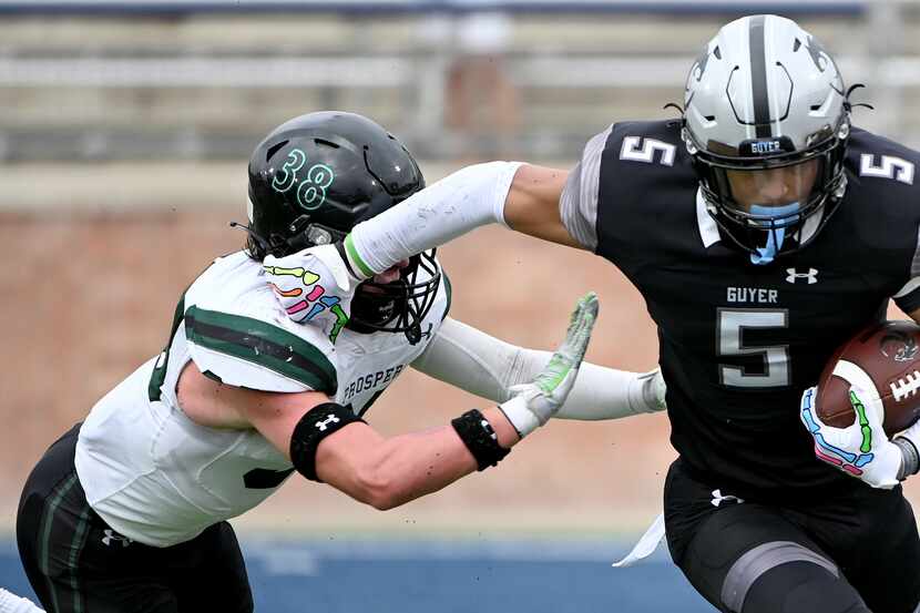 Denton Guyer's Jace Wilson (5) runs past Prosper's Jonah McClendon (38)  the first half of a...