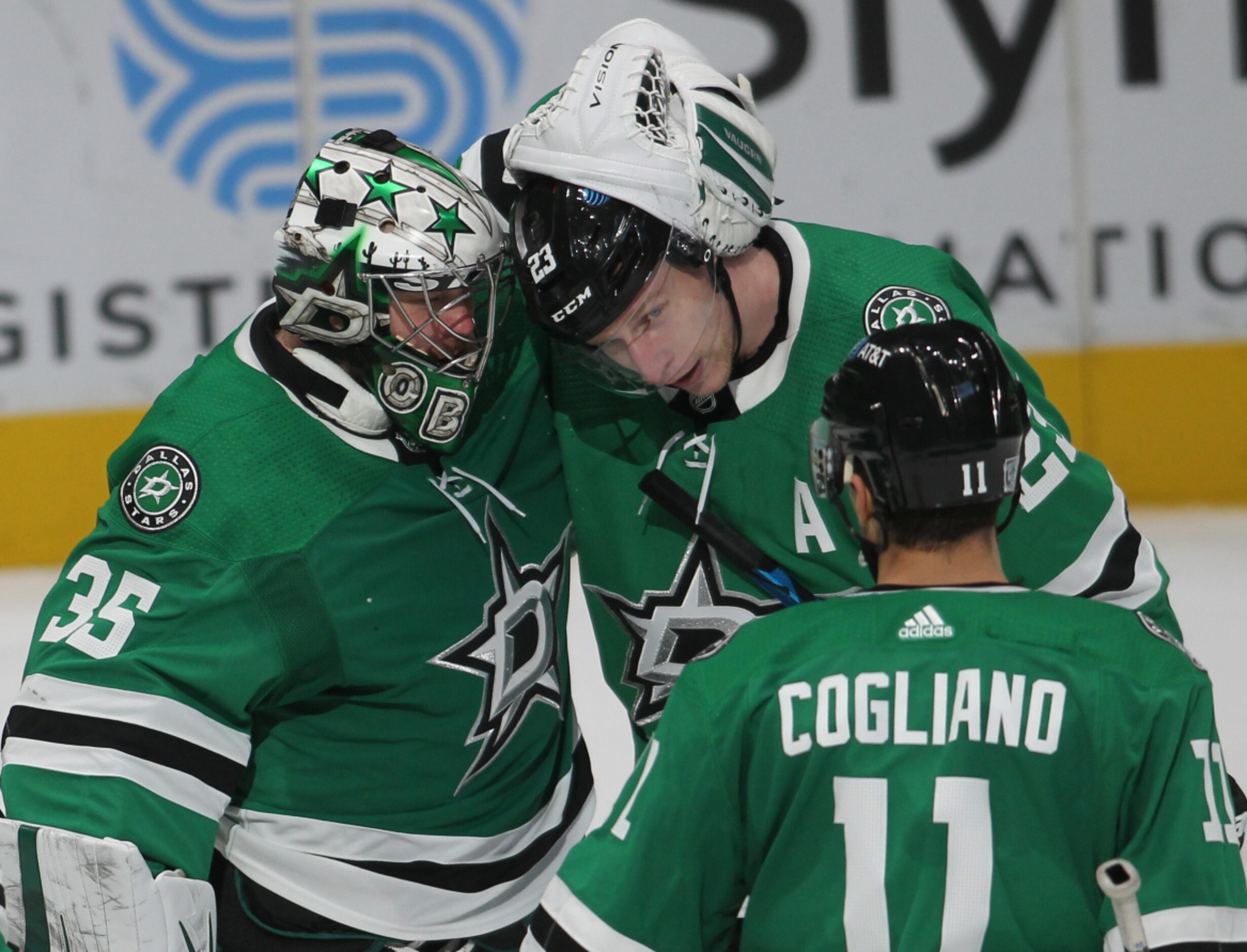 Dallas Stars goalie Anton Khudobin (35), left, shares a hug with teammate Esa Lindell (23)...