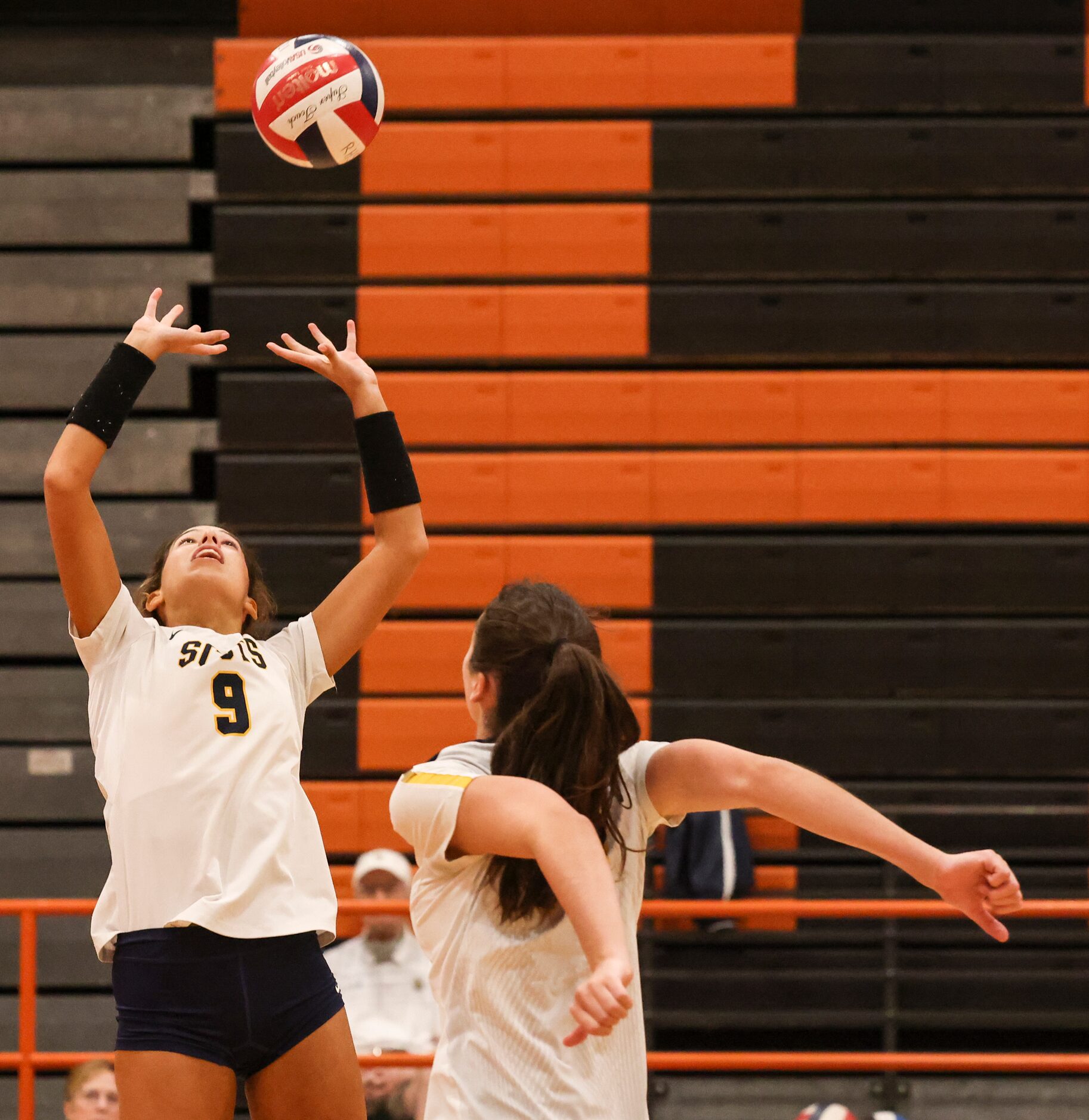 Highland Park High School’s Gracie Braner sets the ball during the volleyball game between...