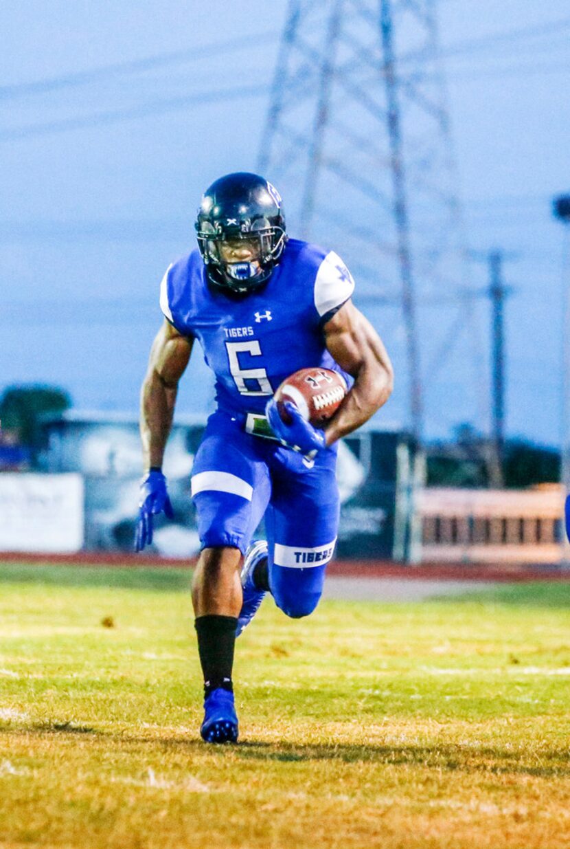 Trinity Christian running back Qualan Jones (6) runs the ball down the field during a high...