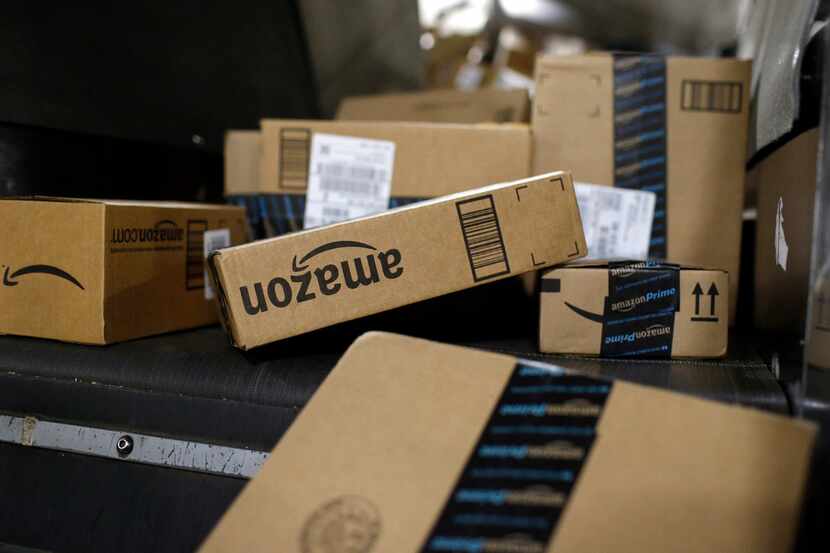 Packages shipped in Amazon boxes ride a conveyor belt at the UPS Worldport hub in...