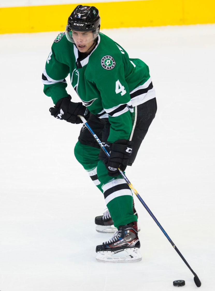 Dallas Stars defenseman Miro Heiskanen (4) takes the puck during the first period of an NHL...