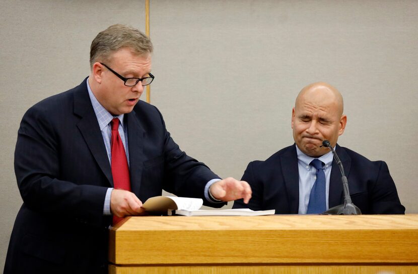 Dallas Officer Martin Rivera grimaces as prosecutor Jason Hermus shows him explicit texts...