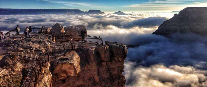 Fog obscures the view for visitors at the Grand Canyon. 