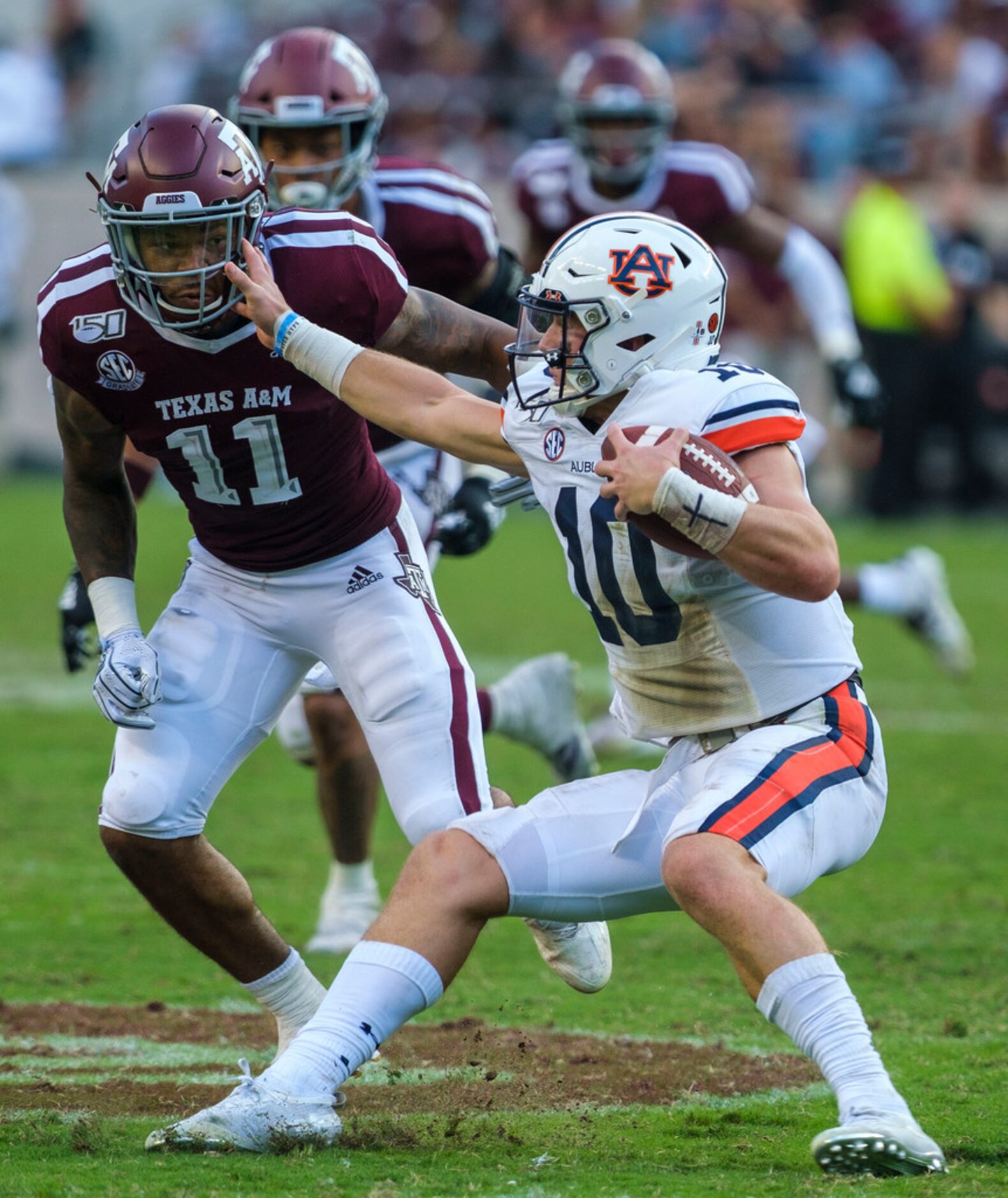 Auburn quarterback Bo Nix (10) slips away from Texas A&M defensive back Larry Pryor (11)...