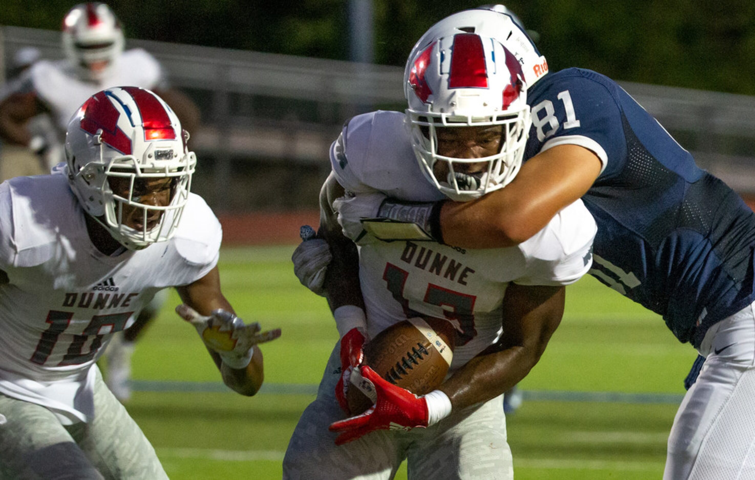 All Saints' Episcopal tight end Mitchell Bothwell (81) tackles Bishop Dunne linebacker John...