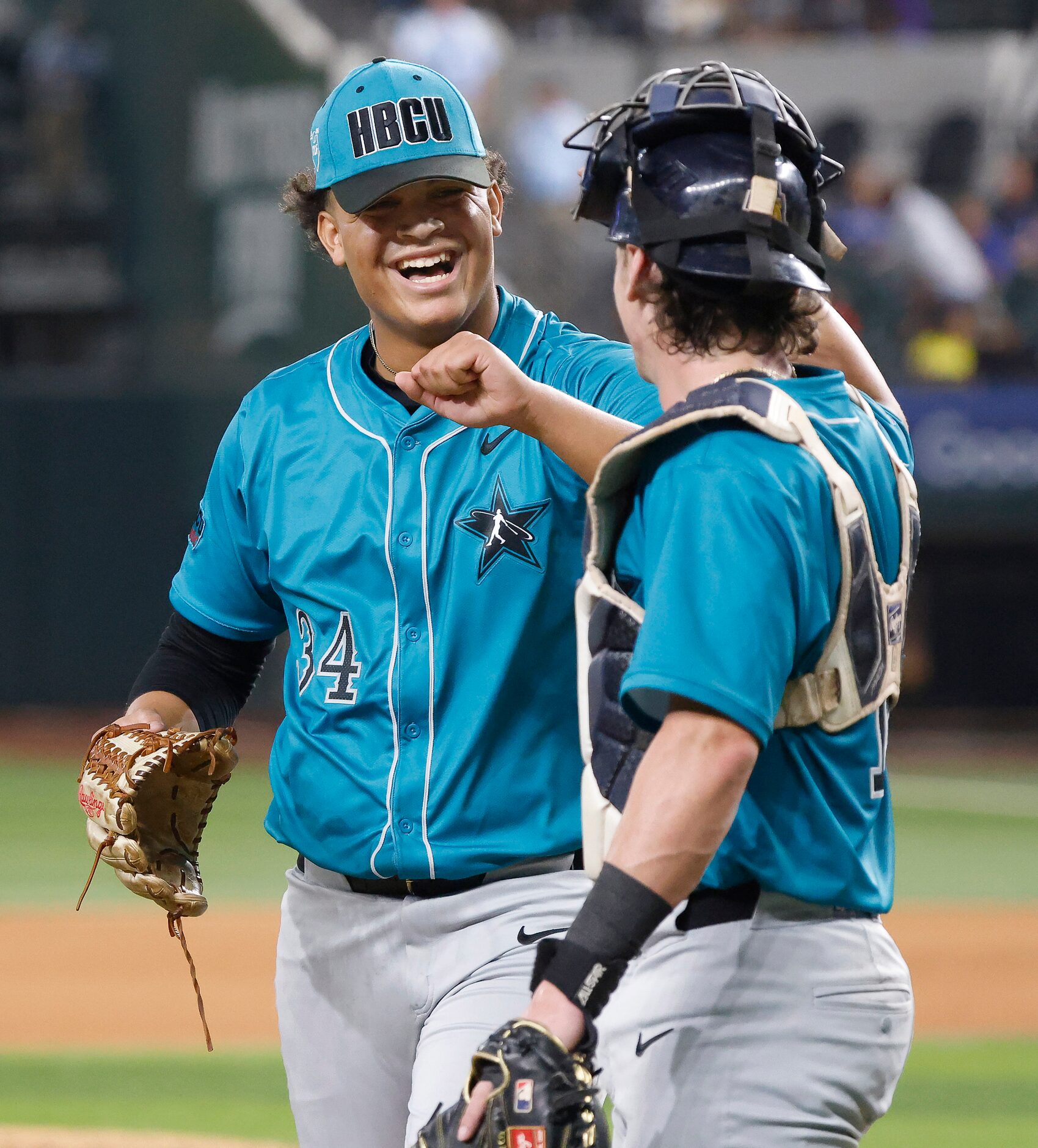 National League pitcher Isaiah Williams (34) is congratulated by catcher Canyon Brown after...